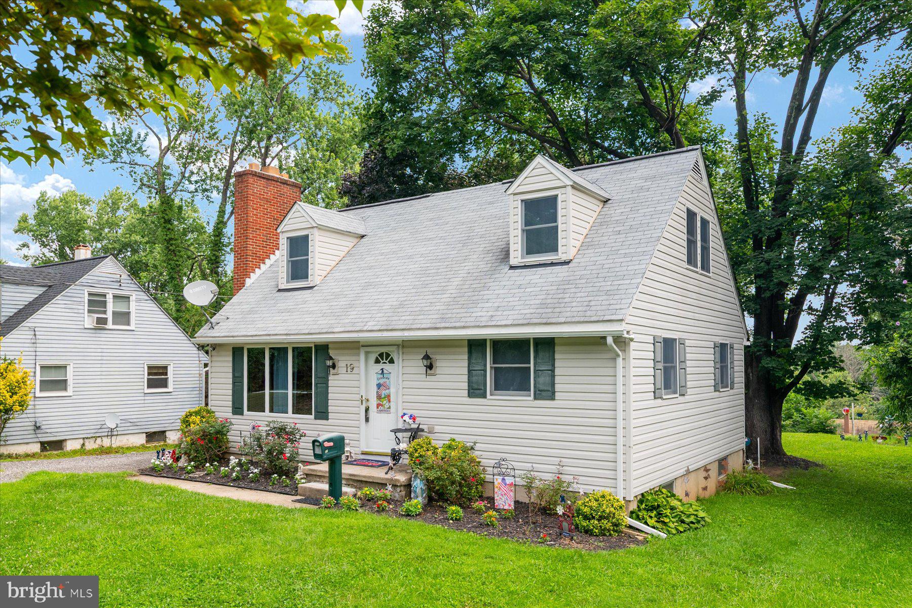19 Old Tollgate Road Owings Mills, MD 21117 - Photo 36 of 37 a front view of a house with a garden and yard