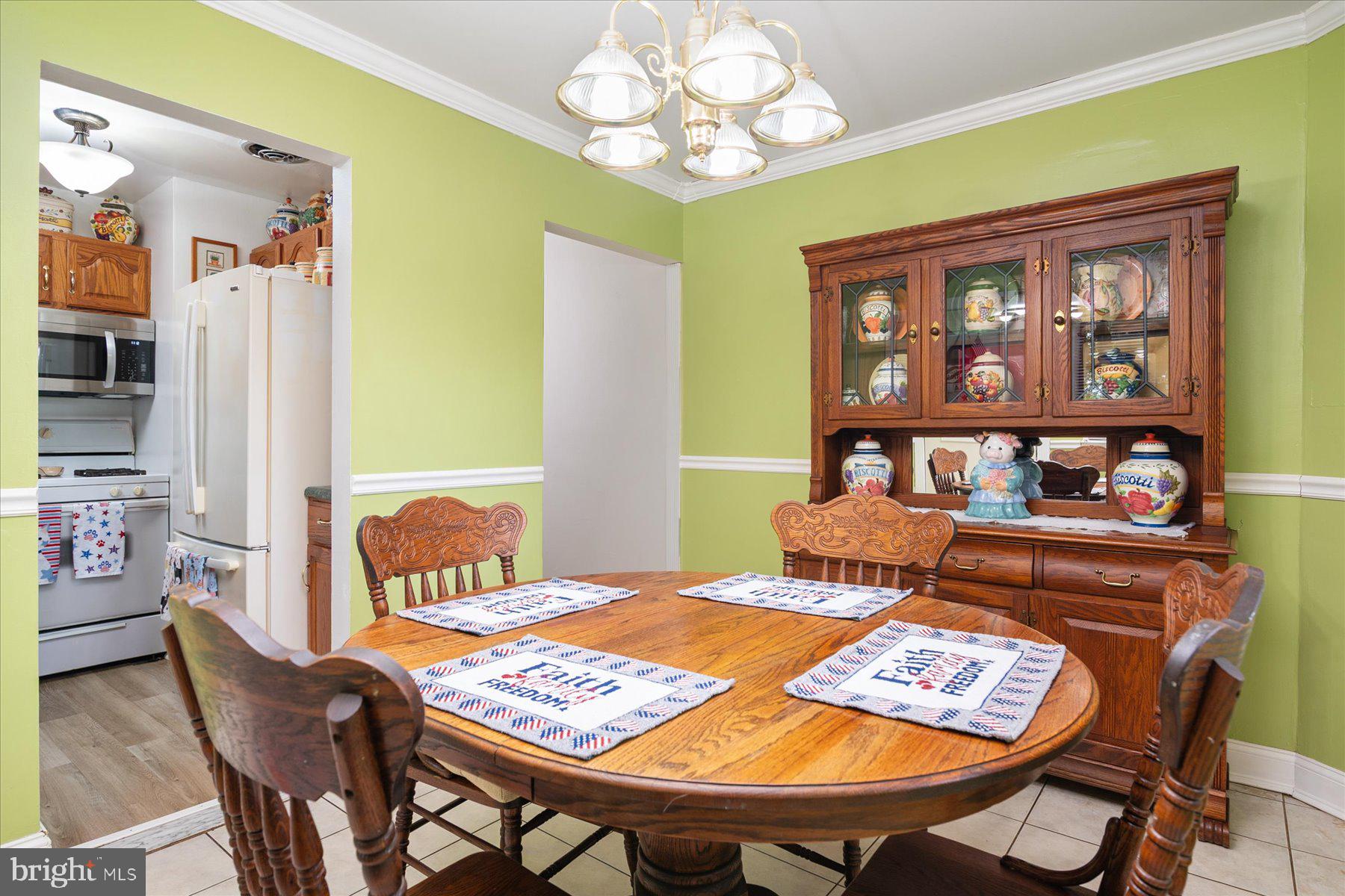 19 Old Tollgate Road Owings Mills, MD 21117 - Photo 8 of 37 a view of a dining room with furniture and chandelier