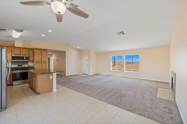 a view of a kitchen with a sink stove and a refrigerator
