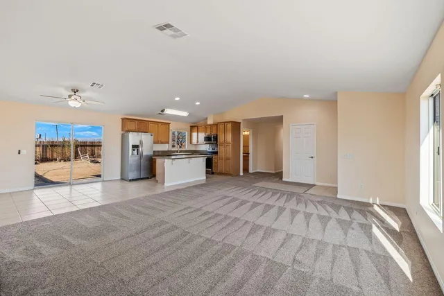 a view of a kitchen with a sink and a refrigerator