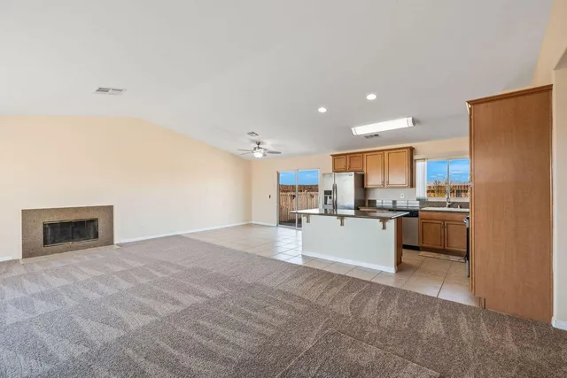 a large kitchen with a refrigerator a stove top oven a sink and dishwasher