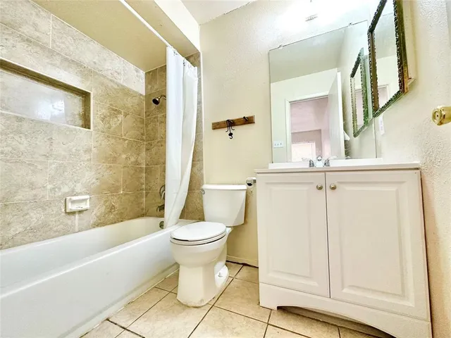a bathroom with a toilet a sink and bathtub