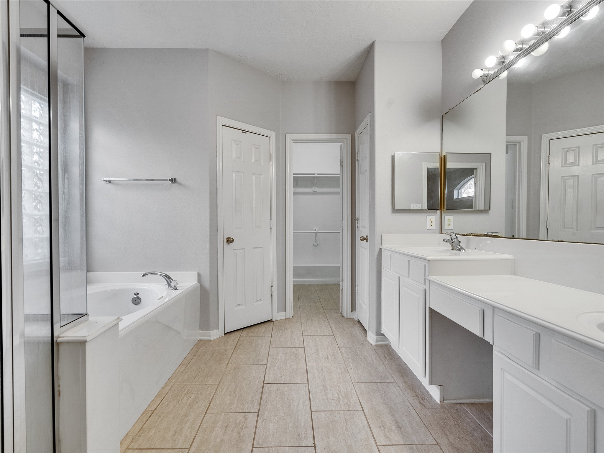 2615 Fern Lacy Drive Spring, TX 77388 - Photo 17 of 32 The primary bath features dual vanity sinks, a shower, a soaking tub and large walk-in closet