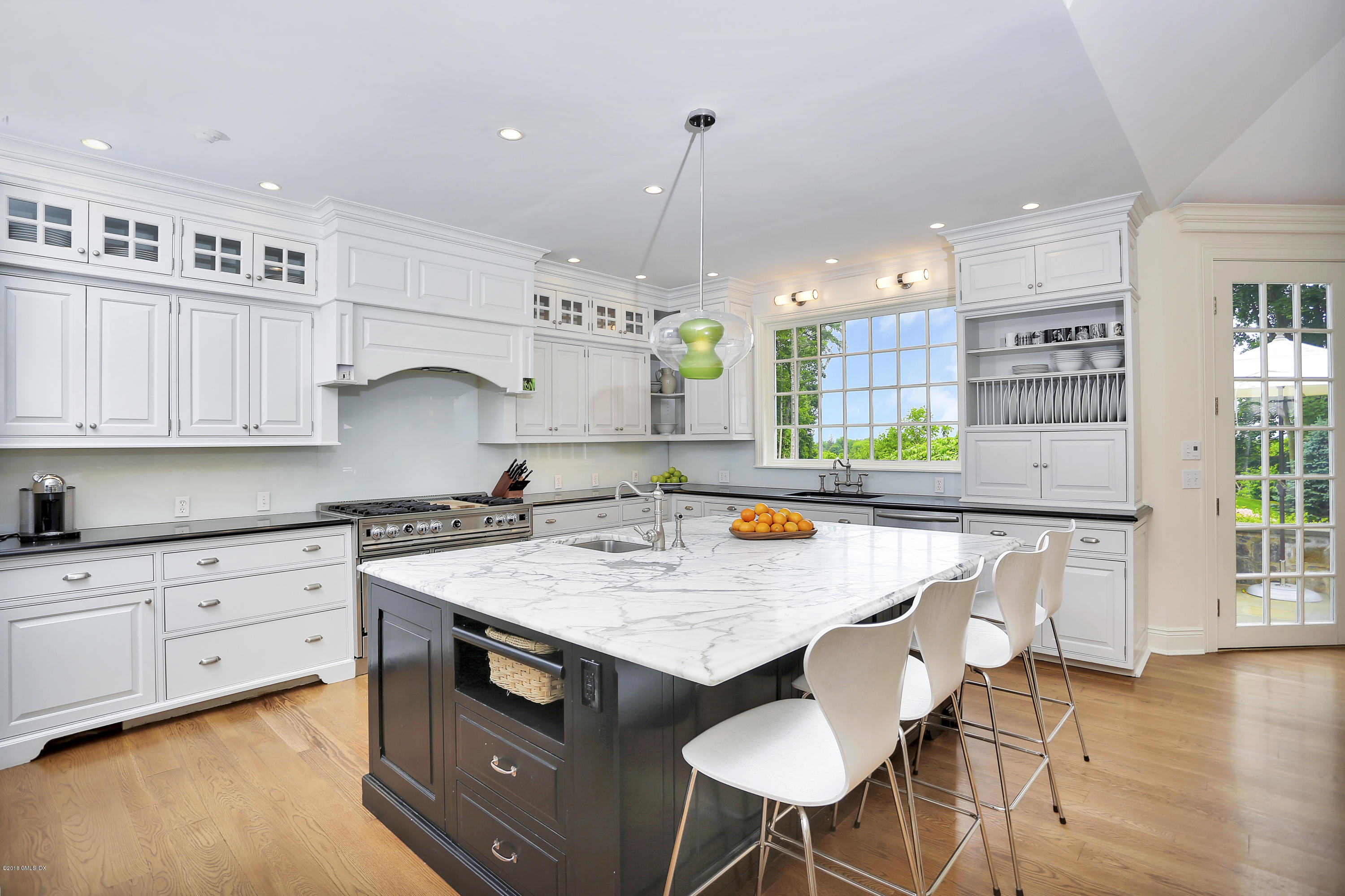 5 Dairy Road Greenwich, CT 06830 - Photo 8 of 32 a kitchen with stainless steel appliances granite countertop a stove a sink dishwasher and white cabinets with wooden floor