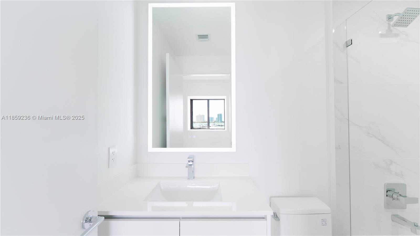 700 Northeast 24th Street, Unit 3605 Miami, FL 33137 - Photo 24 of 44 a bathroom with a sink a toilet and a mirror