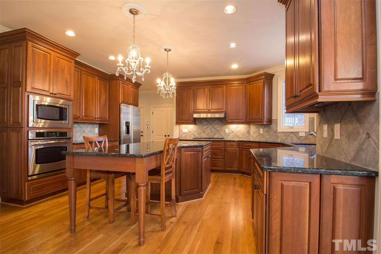 1068 Tacketts Pond Drive Raleigh, NC 27614 - Photo 12 of 25 Amazing gourmet kitchen with large center island, granite counters, stainless steel appliances, tons of cabinet and counter space. Also enjoy the perfect breakfast area with fireplace and cozy keeping room Kitchen
