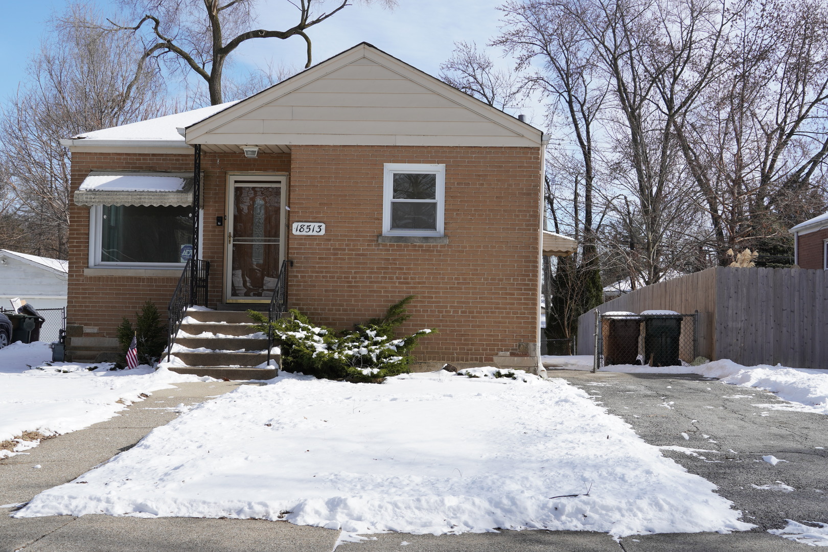 a view of a house with a yard covered in snow