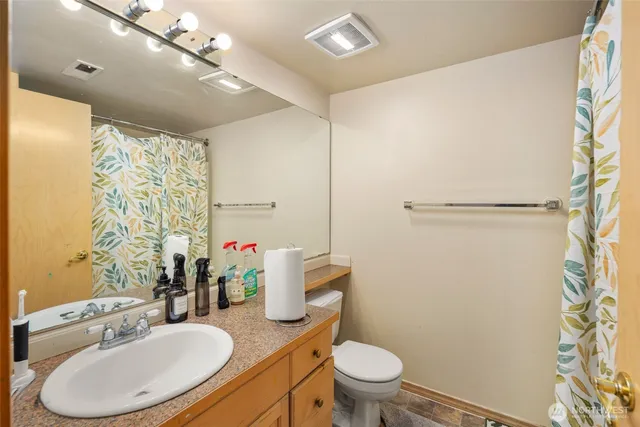 a bathroom with a sink toilet and shower