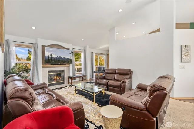 a living room with furniture fireplace and flat screen tv