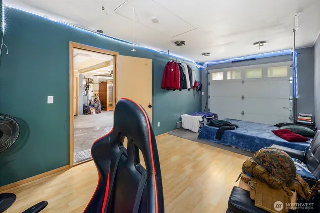 a bed room with furniture and a mirror