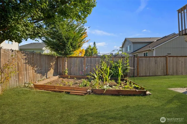 a backyard of a house with table and chairs