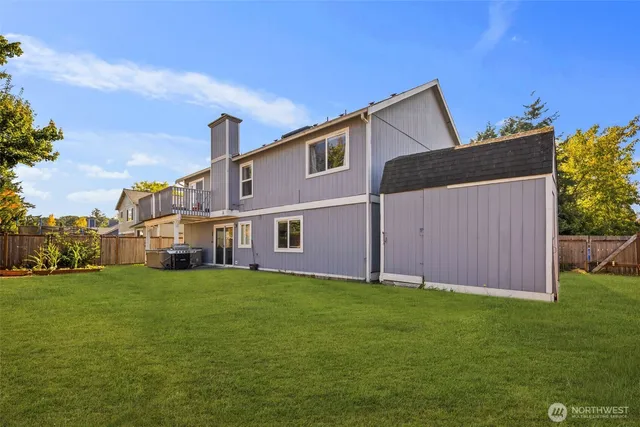 a view of a house with a yard and pathway