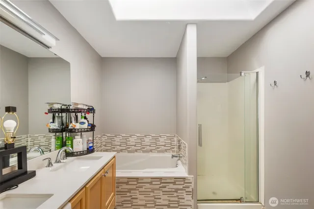 a bathroom with a granite countertop shower a sink and a mirror