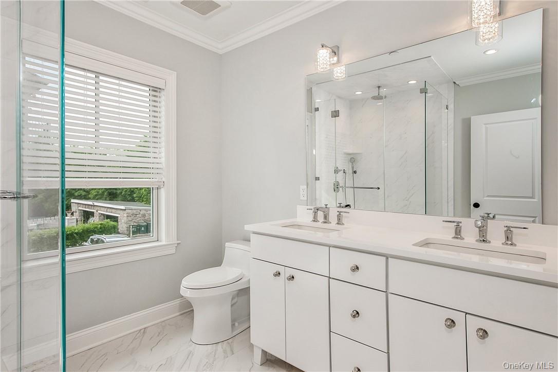 124 B Maple Avenue Rye, NY 10580 - Photo 12 of 27 a bathroom with a granite countertop sink toilet a large mirror next to a window