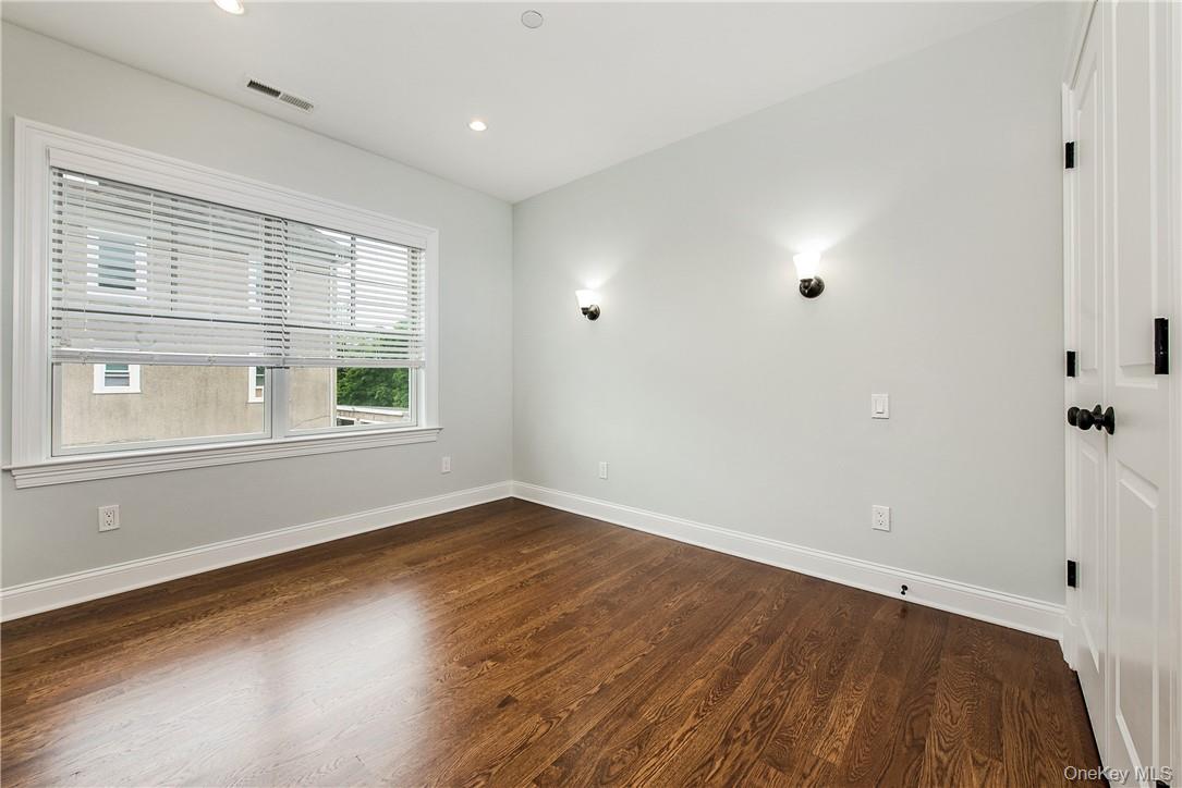 124 B Maple Avenue Rye, NY 10580 - Photo 13 of 27 a view of an empty room with wooden floor and a window