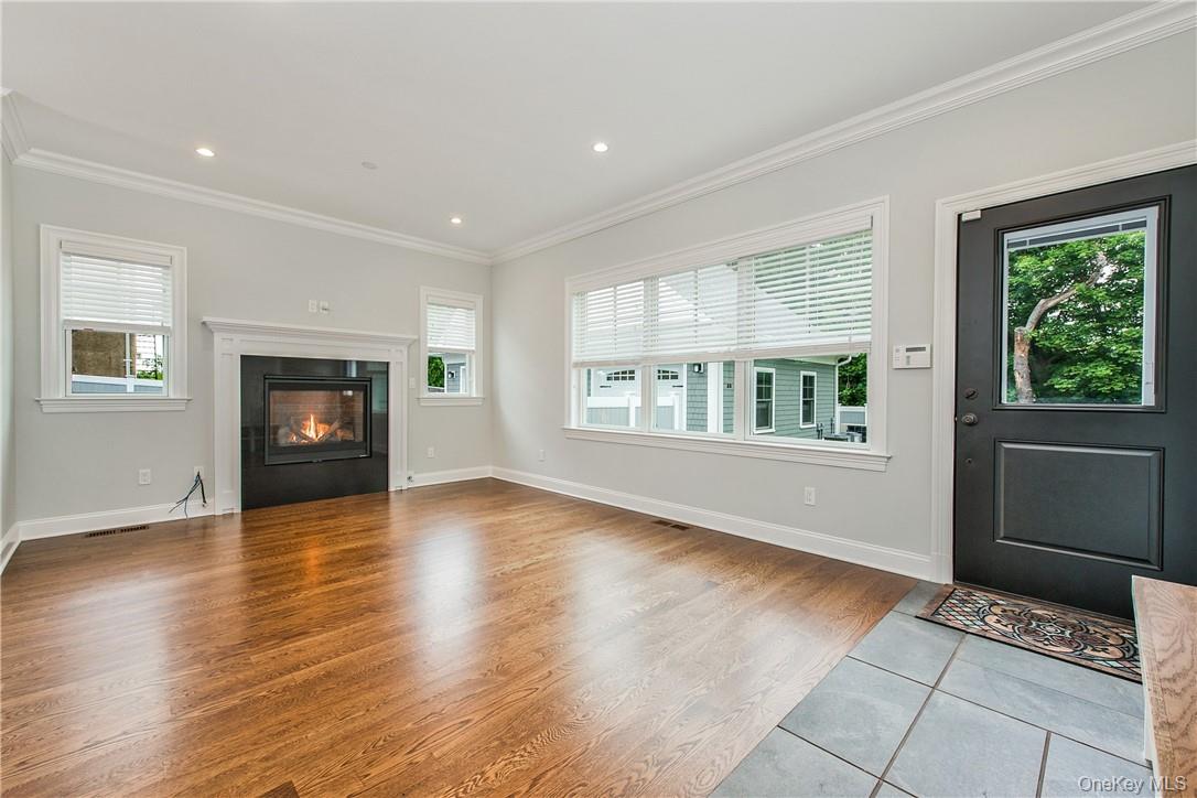 124 B Maple Avenue Rye, NY 10580 - Photo 5 of 27 a view of an empty room with a window and wooden floor