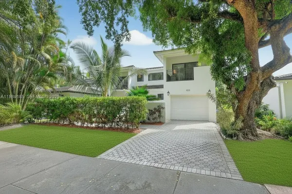 a front view of a house with a garden