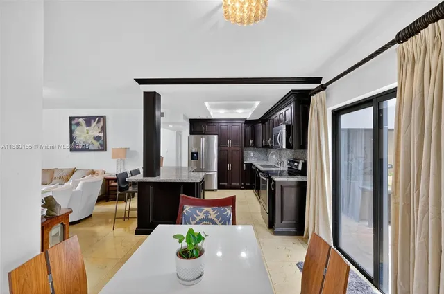 a kitchen with stainless steel appliances granite countertop a refrigerator and a stove top oven