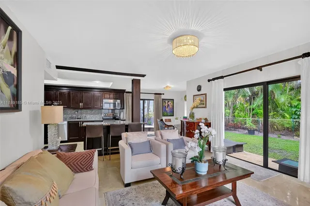 a living room with fireplace furniture and a large window