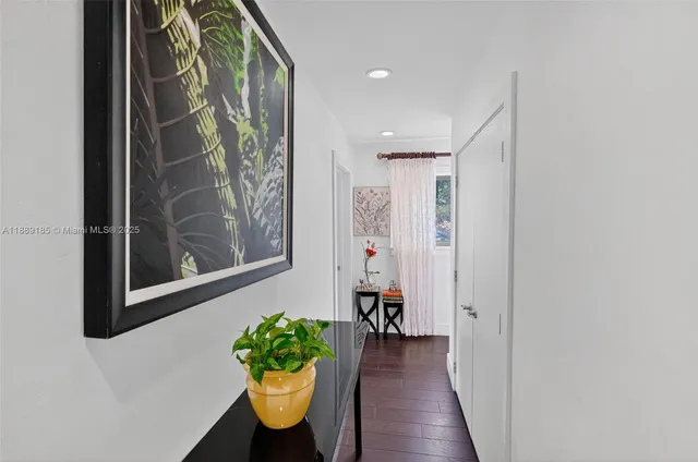 a bedroom with a bed and a dresser next to a window