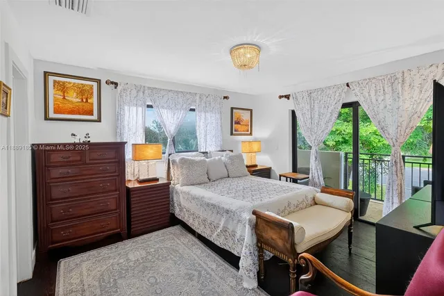 a bedroom with furniture and a flat screen tv