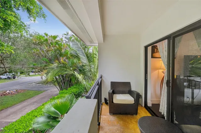 a bedroom with a bed couch and a large window