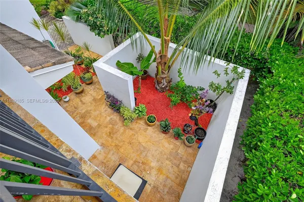 a bedroom with a bed couch and a large window