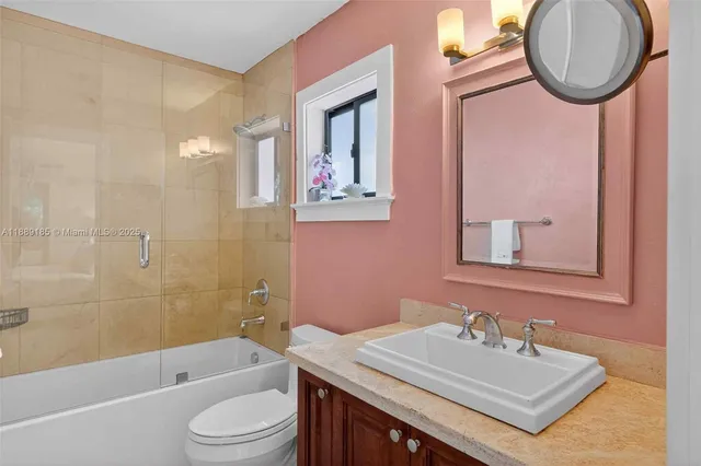 a view of a city from a dining room with large windows and plants