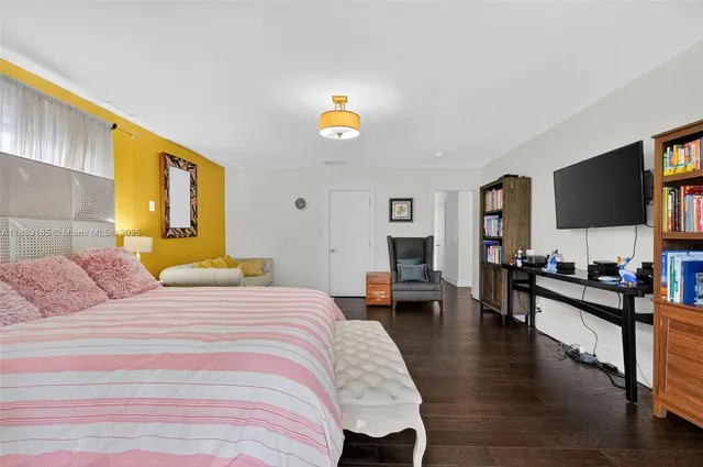 a room with a table chairs and a refrigerator