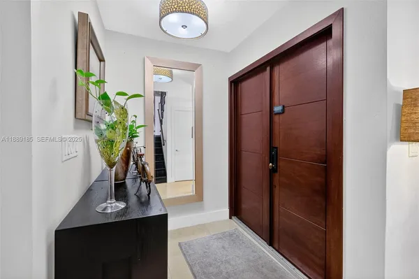 a view of bathroom with a potted plant on a sink and a mirror