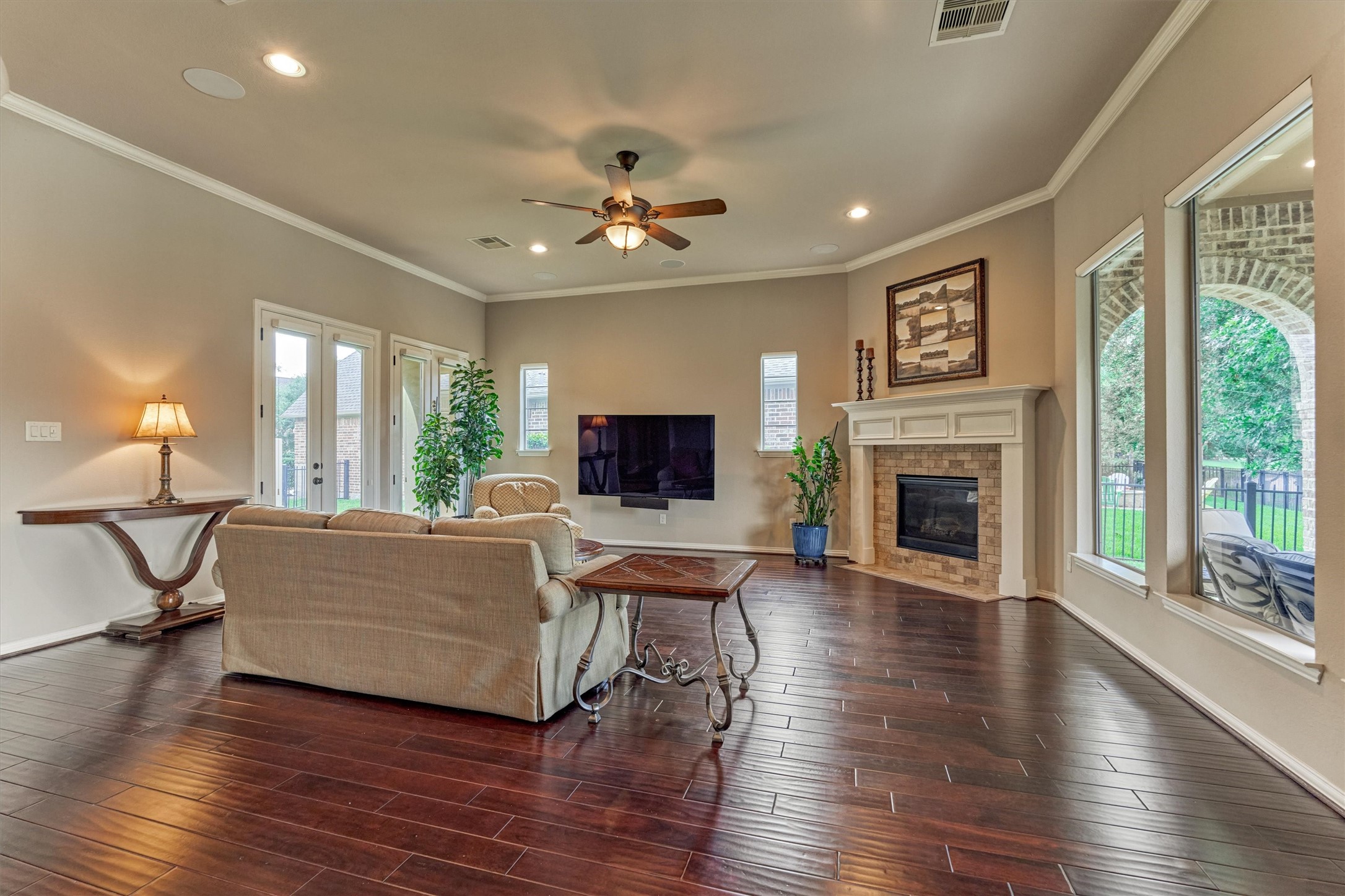 82 East Crystal Canyon Circle The Woodlands, TX 77389 - Photo 15 of 50 The spacious great room features direct access to the private side yard through exterior doors.Relax beside the cozy fireplace and enjoy year-round comfort.