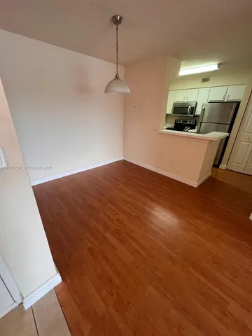 a view of a kitchen with a sink and cabinets