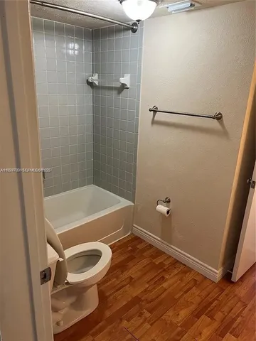 a bathroom with a shower and a toilet