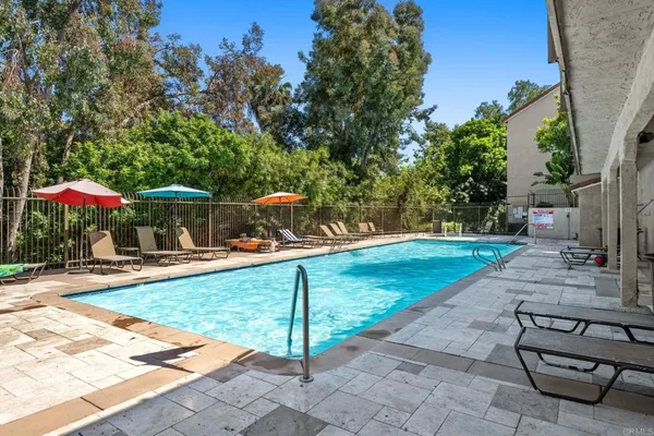 swimming pool view with a seating space