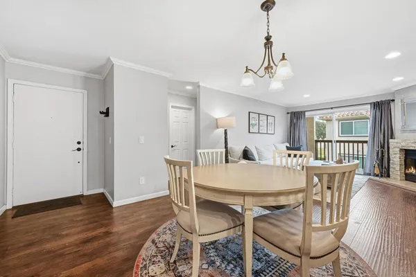 a view of a dining room with furniture wooden floor and chandelier