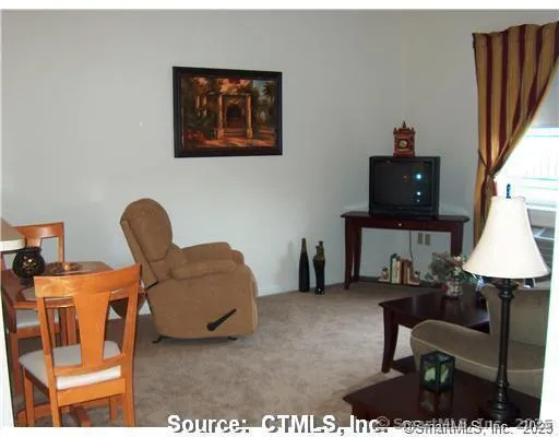 a living room with furniture and a lamp