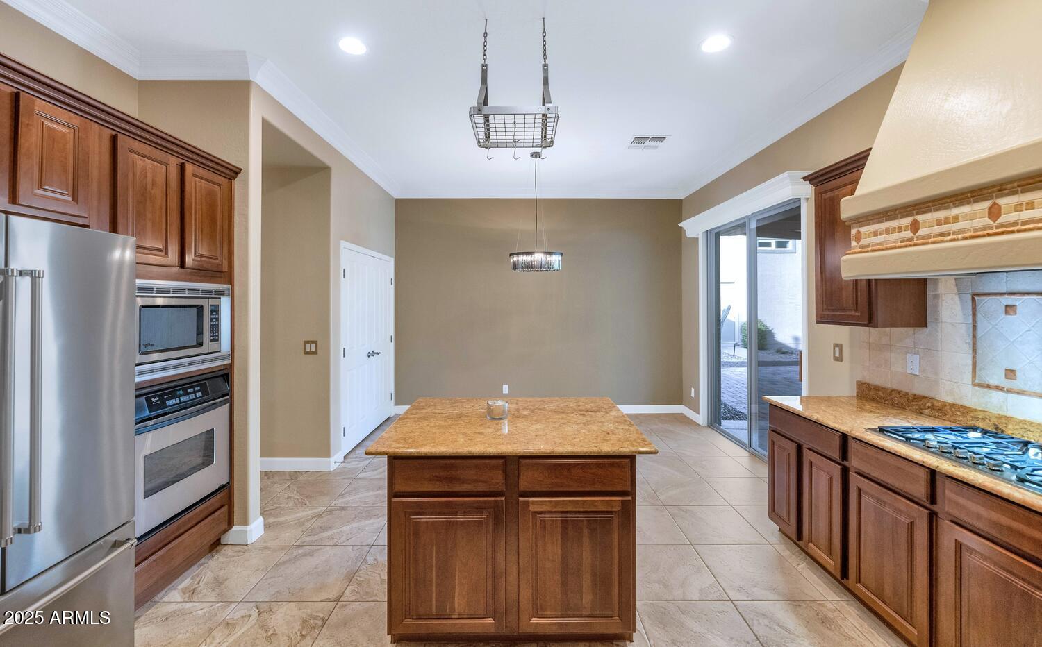 14426 West Becker Lane Surprise, AZ 85379 - Photo 17 of 68 a kitchen with granite countertop a stove and a refrigerator