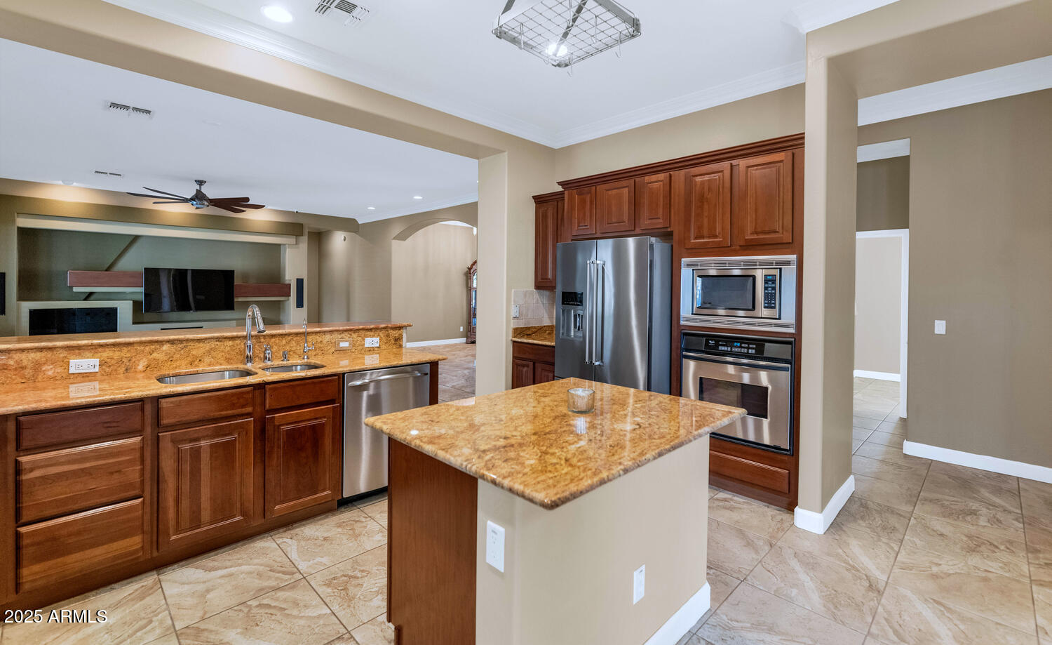 14426 West Becker Lane Surprise, AZ 85379 - Photo 19 of 68 a kitchen with stainless steel appliances kitchen island granite countertop a refrigerator and a stove top oven