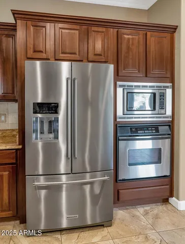 a view of an empty room with a ceiling fan and window