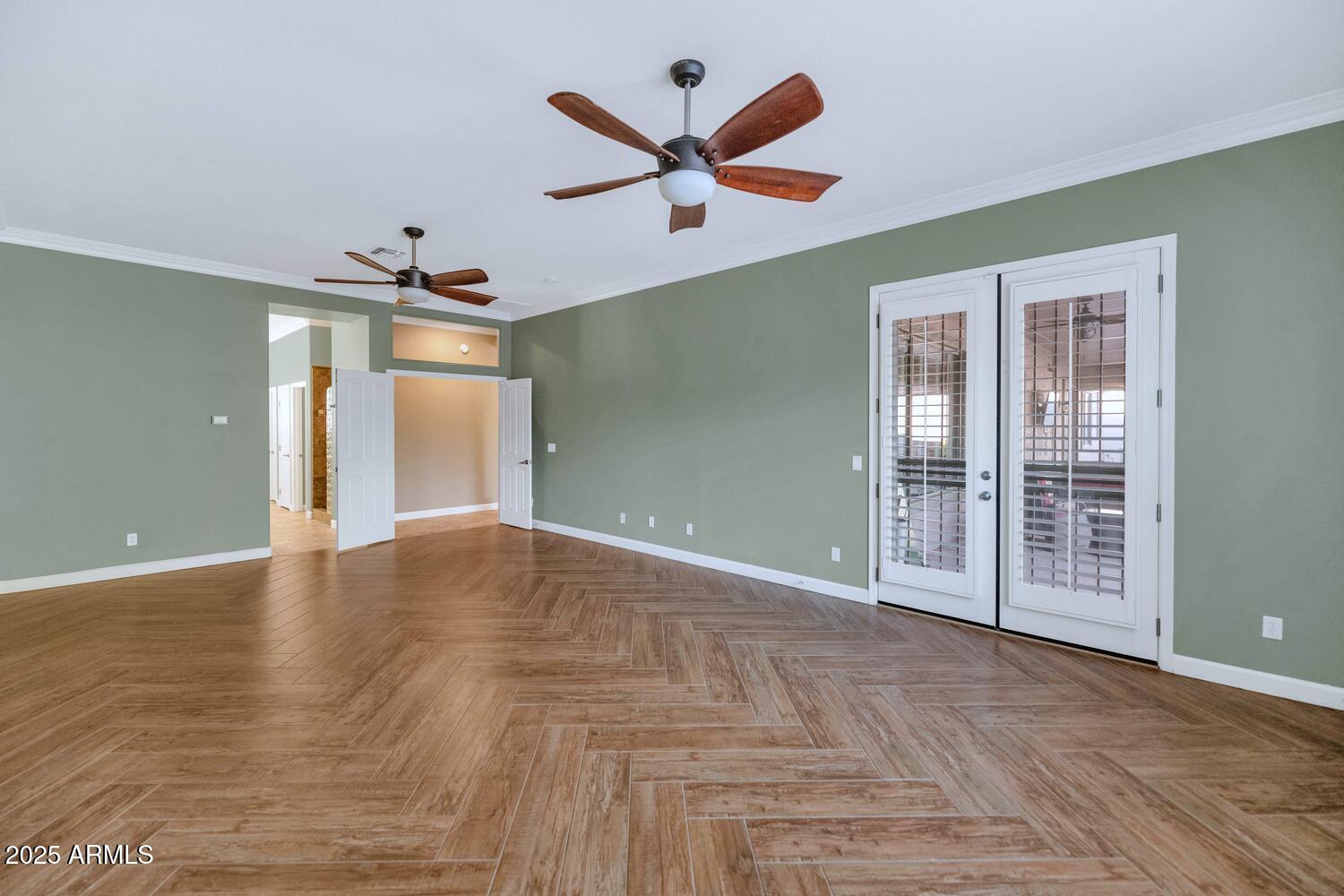 14426 West Becker Lane Surprise, AZ 85379 - Photo 25 of 68 a view of an empty room with a ceiling fan and window