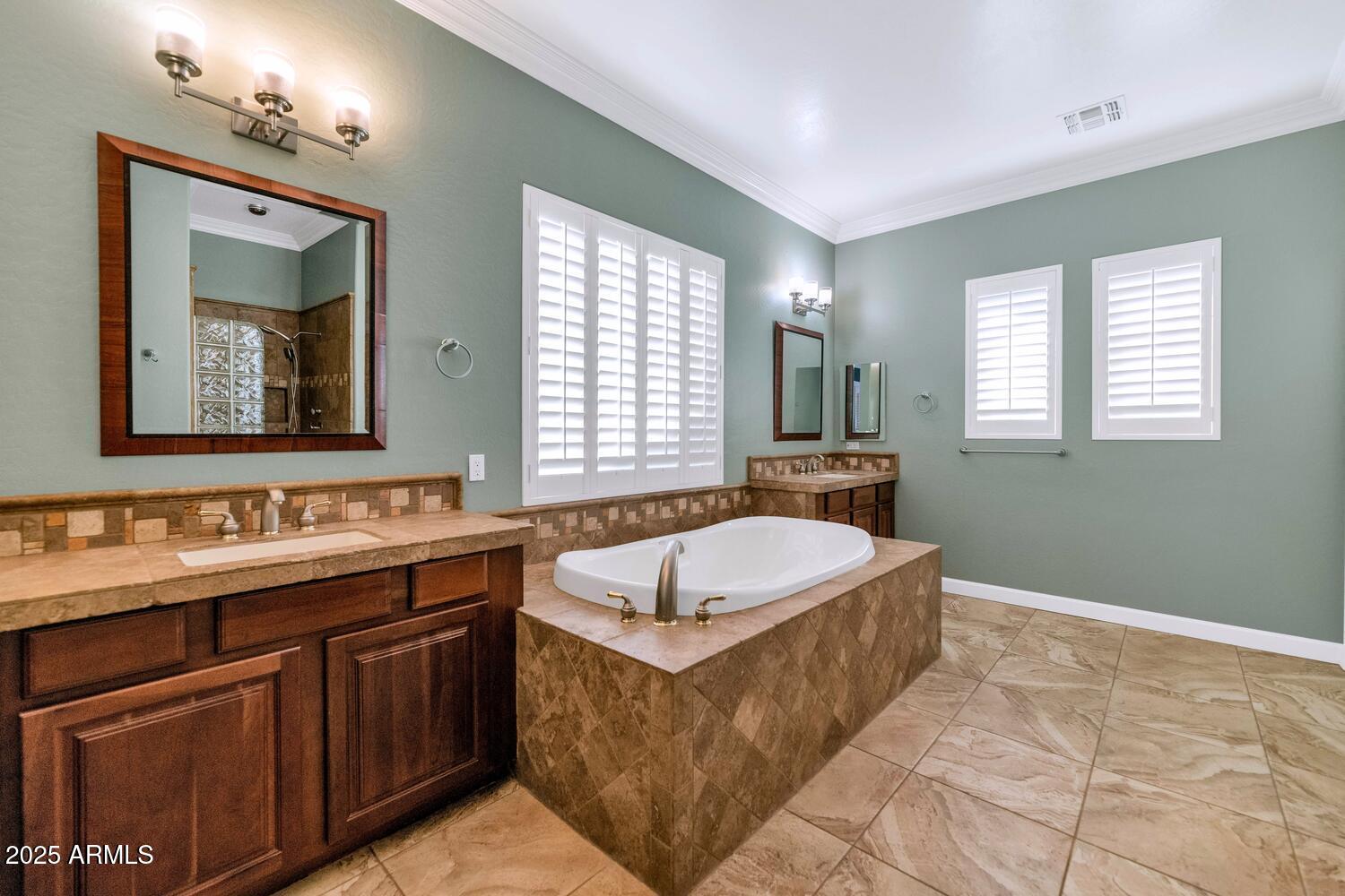 14426 West Becker Lane Surprise, AZ 85379 - Photo 26 of 68 a spacious bathroom with a tub sink and mirror