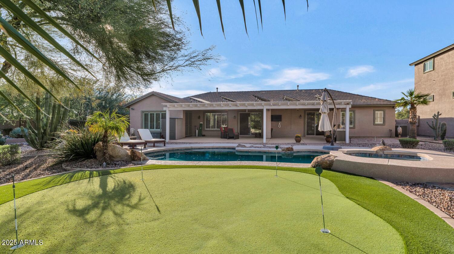 14426 West Becker Lane Surprise, AZ 85379 - Photo 2 of 68 a view of a house with swimming pool and a chairs