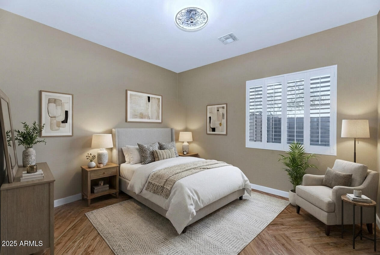 14426 West Becker Lane Surprise, AZ 85379 - Photo 30 of 68 a bedroom with a large bed and a couch