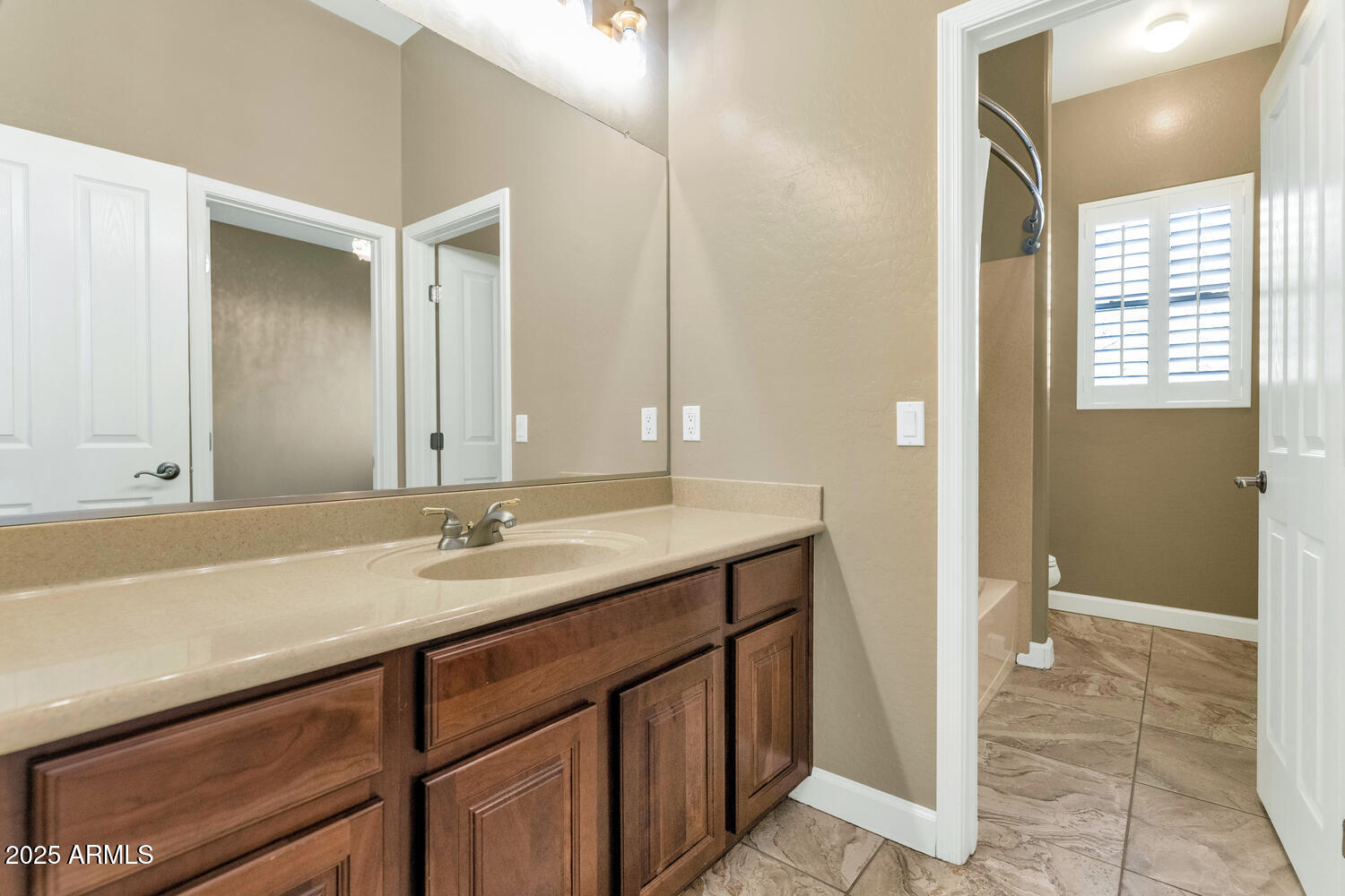 14426 West Becker Lane Surprise, AZ 85379 - Photo 32 of 68 a bathroom with a granite countertop sink and a mirror