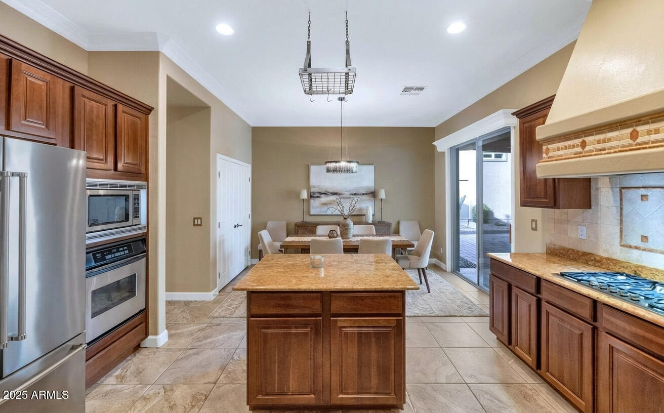 14426 West Becker Lane Surprise, AZ 85379 - Photo 5 of 68 a large kitchen with granite countertop a stove refrigerator and a sink