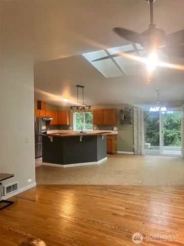a view of a kitchen with a sink and a large window