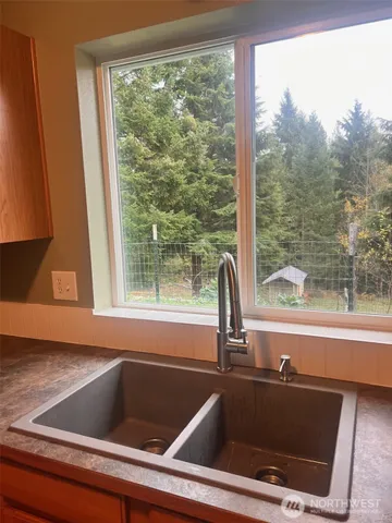 a view of a sink and table in a kitchen
