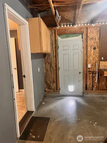 a view of a room with wooden floor and windows