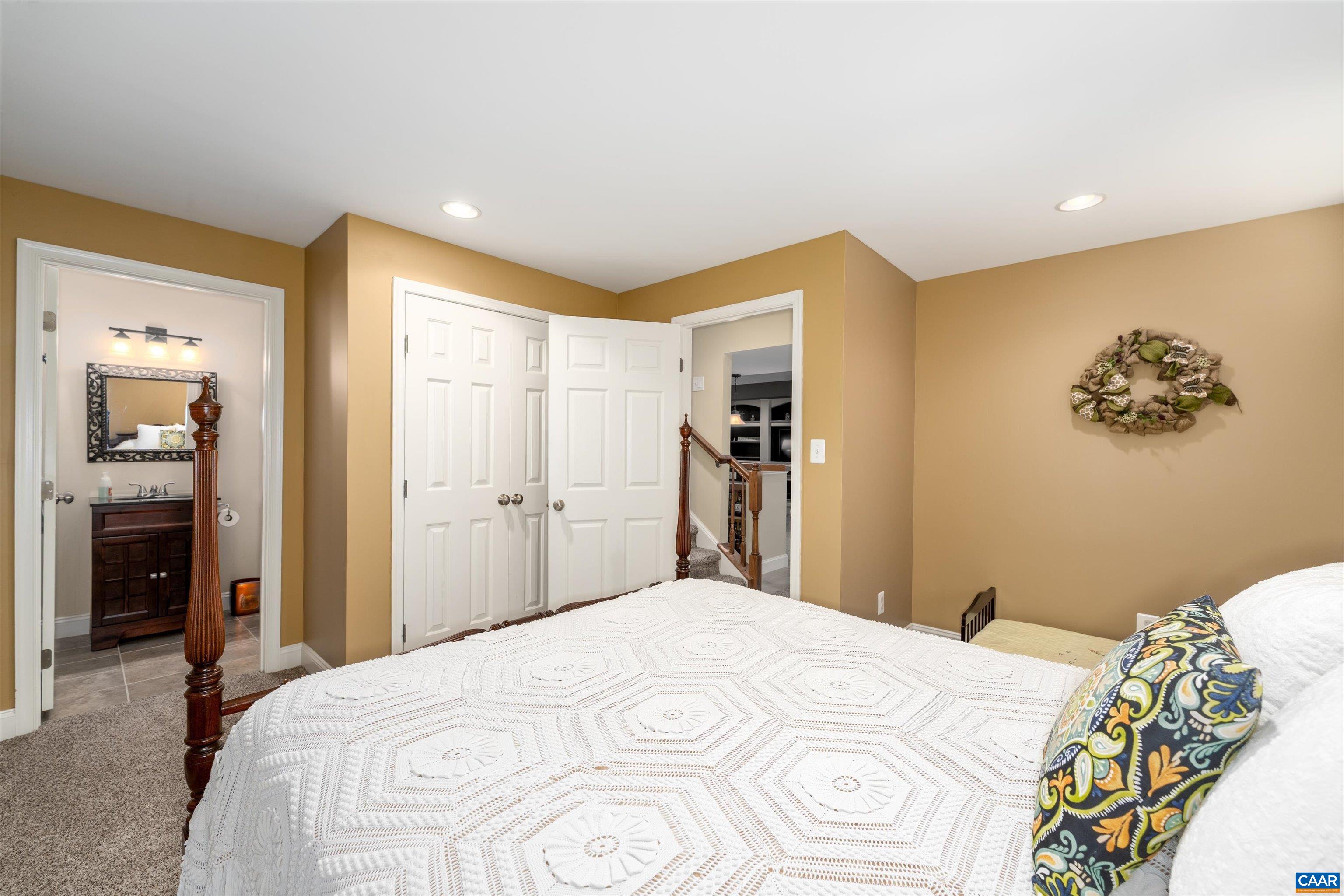 5366 Park Road Crozet, VA 22932 - Photo 56 of 61 a bedroom with a large bed a chandelier and closet