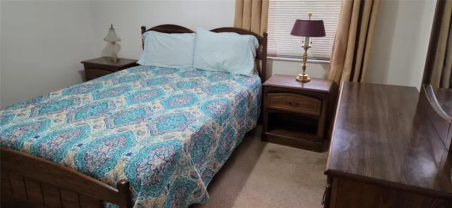 a bedroom with a bed and a mirror